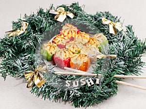 Christmas sushi. New Year sushi. Sushi and Christmas wreath.