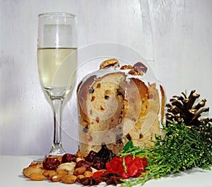 Christmas sweet bread and dried fruits and glaze and glass of champane