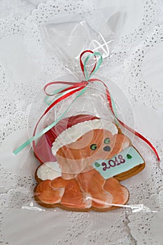 Christmas sweets in a festive package, colorful gingerbread, cookie in the form of a dog with New Year`s mood. Year of
