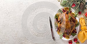 Christmas table with baked chicken is festively decorated with candles. top view