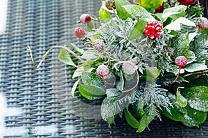 Christmas table decor background with red berries and snow