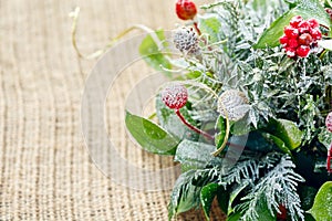 Christmas table decor background with red berries and snow