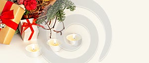 Christmas table decoration banner. Green fir branches candle gift boxes blue balls lights isolated white background