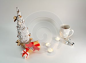 Christmas table decoration banner. White hand made fir. Craft paper red gift boxes recycle materials candles lights cup