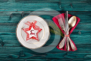 Christmas table decoration. Christmas dinner plate, cutlery decorated festive decorations. Winter holidays. Christmas card.