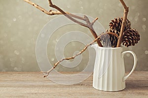 Christmas table decoration with jug and winter branches