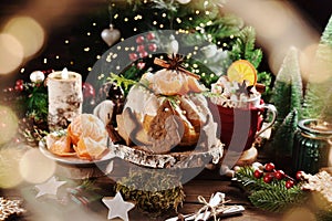 Christmas table with mandarin flavored ring cake decorated with fresh fruits