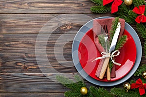 Christmas table place setting with christmas decor and plates, kine, fork and spoon. Christmas holiday background. Top