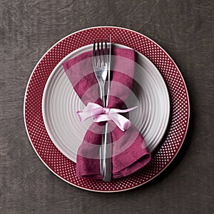 Christmas table place setting with empty gray and red plates with tableware at wood background