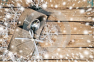 Christmas table place setting and silverware, snowflakes with sn