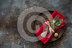 Christmas table place setting. Tableware with evergreen twigs, co