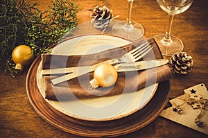 Christmas table place setting in vintage or rustic style.