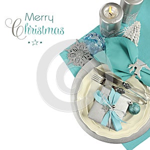 Christmas table place settings in aqua blue, silver and white