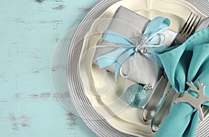 Christmas table place settings in aqua blue, silver and white