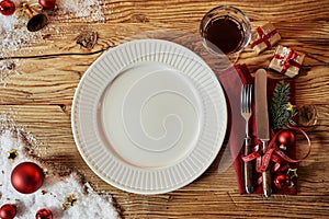 Christmas table set with decorations and a plate