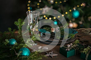 Christmas table setting with black ceramic plate and gift boxes