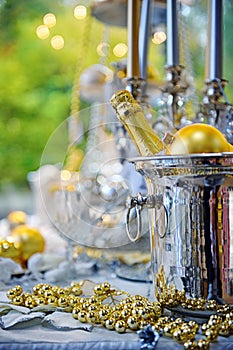 Christmas table setting with bottle of champagne