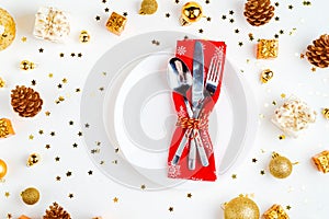 Christmas table setting. Christmas decorations, fork, spoon, knife, red napkin. Top view