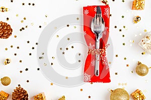 Christmas table setting. Christmas decorations, fork, spoon, knife, red napkin. Top view