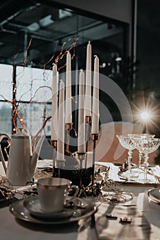 Christmas table setting with cups, candles, glasses. Teatime