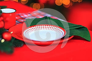 Christmas Table Setting. Holiday Decorations. Decor. Festive Christmas table decorations. Plate with napkin and tablecloth served