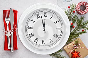 Christmas table setting with plate clock, napkin and cutlery