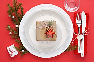 Christmas table setting on red background. Xmas celebration