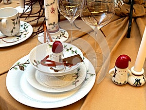Christmas table setting with white festive plates