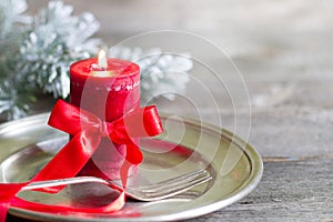 Christmas table with silver ware and red candle