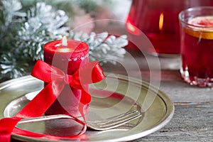 Christmas table with silver ware and red candle