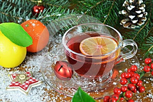 Christmas tea in transparent cup and Christmas decoration