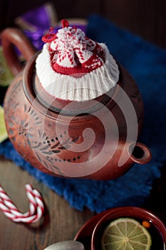 Christmas teapot with the red santa hat on it.