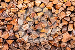 Christmas texture background of dry wooden log cabins. Woodpile of cut Lumber for forestry industry