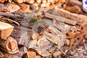 Christmas texture background of dry wooden log cabins. Woodpile of cut Lumber for forestry industry