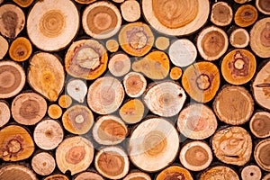 Christmas texture background of dry wooden log cabins. Woodpile of cut Lumber for forestry industry