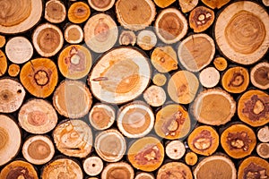 Christmas texture background of dry wooden log cabins. Woodpile of cut Lumber for forestry industry