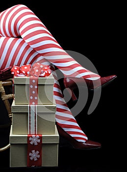 Christmas theme Lady Santa with red and white candy cane stripe stocking legs and gifts