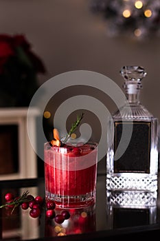 Christmas themed cranberry cocktail with a bottle