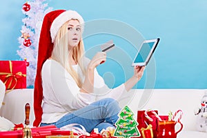 Girl with tablet credit card doing online shopping