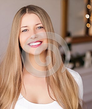 Christmas time and holiday mood concept. Happy smiling woman and decorated xmas tree lights on background