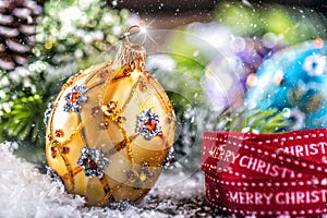 Christmas Time. Luxury golden purple blue christmas ball and decoration.Red ribbon with text happy christmas