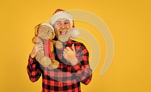Christmas time for mercy. Charity project. Bearded man celebrate christmas. Kind hipster with teddy bear. Charity and