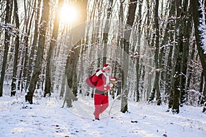 Christmas time with snow. Santa Claus with huge red sack. Merry Xmas and New Year Eve concept.