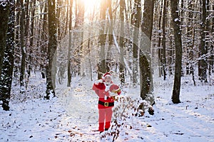 Christmas time with snow. Santa Claus walk in the winter mountains.