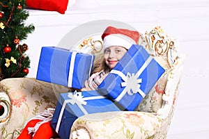 Christmas time and surprise concept. Adorable kid receives presents