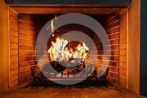 Christmas time. Wood burning in a cozy fireplace at home