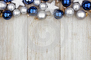 Christmas top border of blue and silver ornaments on gray wood