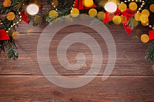 Christmas top border with Christmas decorations and bokeh on wooden background, mockup, flat lay, copy space