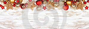 Christmas top border of red and gold ornaments on a white rustic white wood banner background