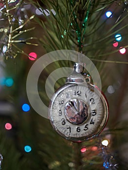 Christmas toy clock on the background of the Christmas tree and